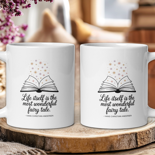 Two white mugs with a book design and quote on a wooden surface.