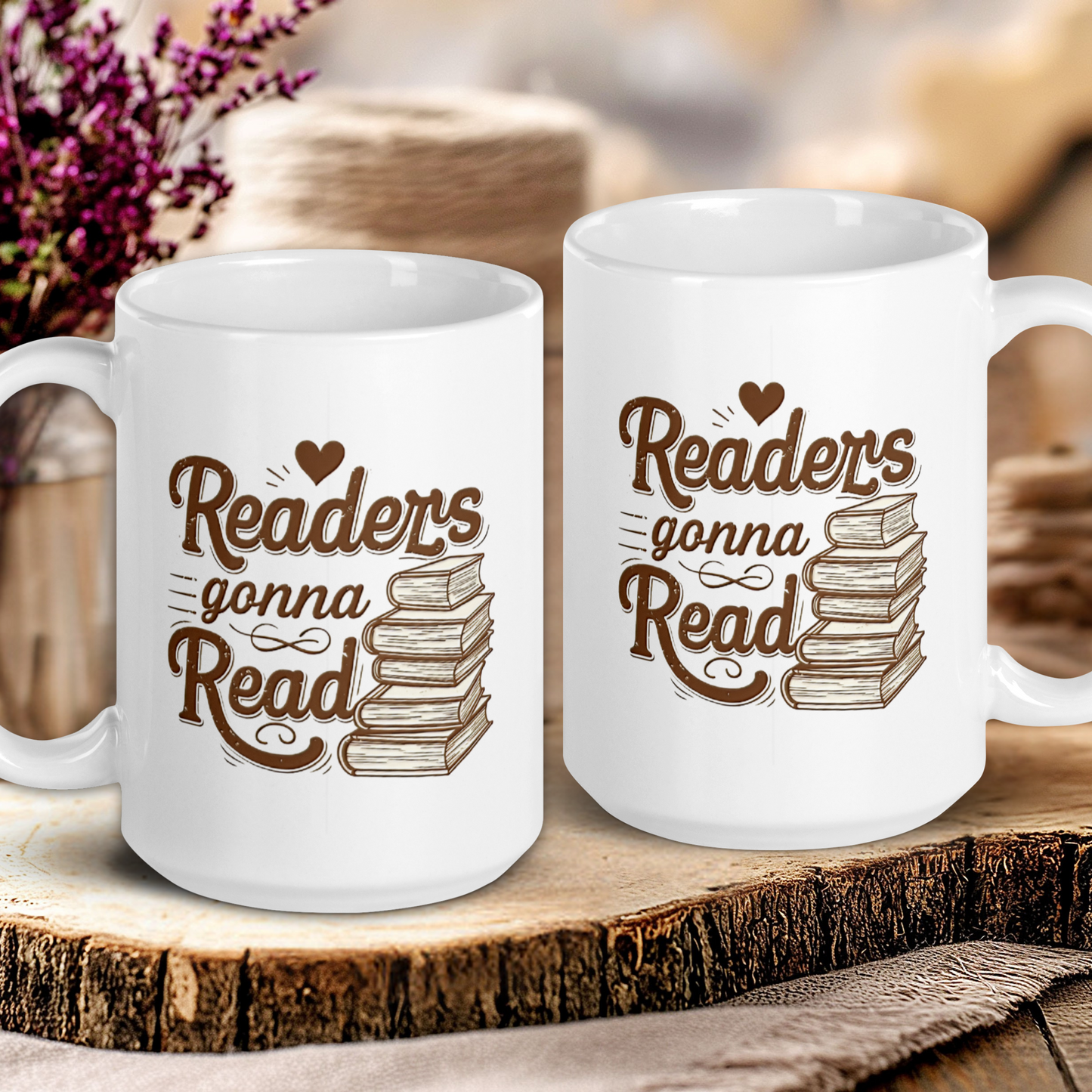 Two white mugs with 'Readers gonna Read' text on a wooden surface with a blurred background.