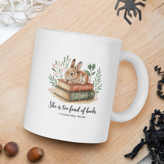 White mug with a rabbit illustration and text on a wooden board with natural elements.