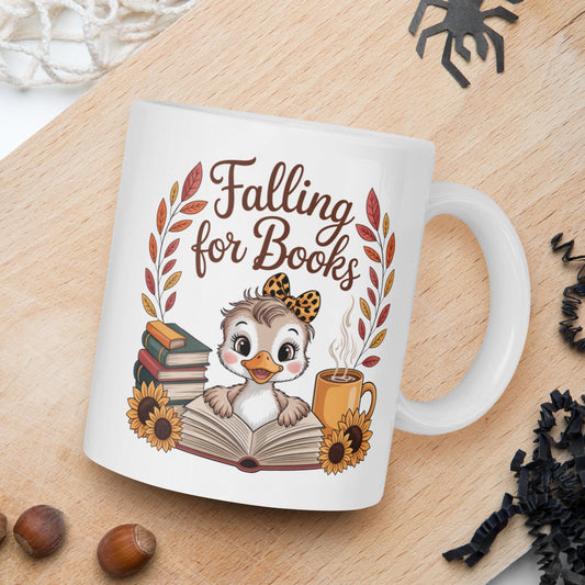 Mug with 'Falling for Books' design featuring a duck and books on a wooden board with autumn elements.