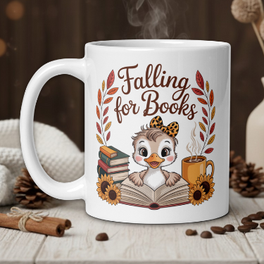 White mug with owl design and 'Falling for Books' text on a wooden table with coffee beans and a vase.
