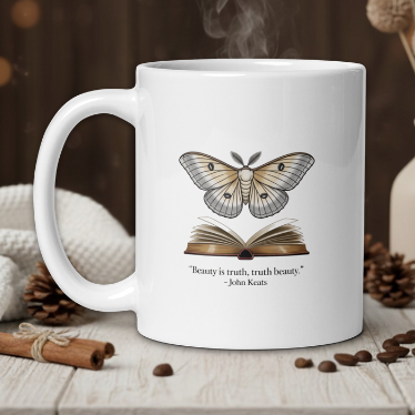 White mug with butterfly and book design on a wooden table with coffee beans and a vase in the background.