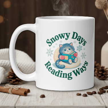White mug with a cat design and text 'Snowy Days Reading Ways' on a wooden table with a warm background.