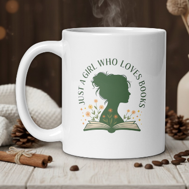 White mug with a design of a girl and book, text 'Just a girl who loves books', on a wooden table with coffee beans and a vase in the background.