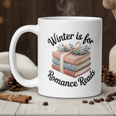 White mug with 'Winter is for Romance Reads' design on a wooden table with coffee beans and a vase.