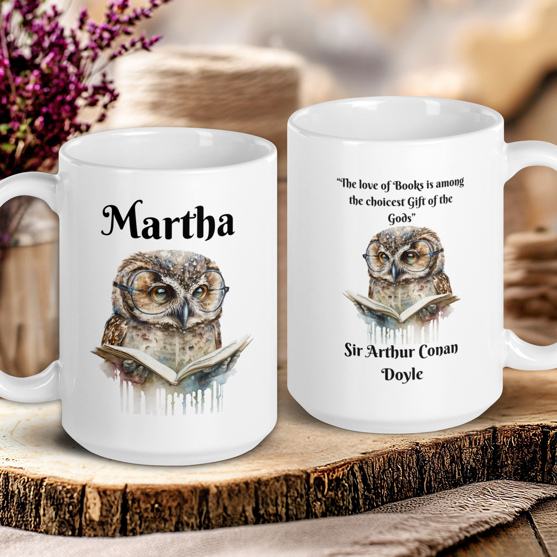 Two white mugs with owl designs and text on a wooden surface.