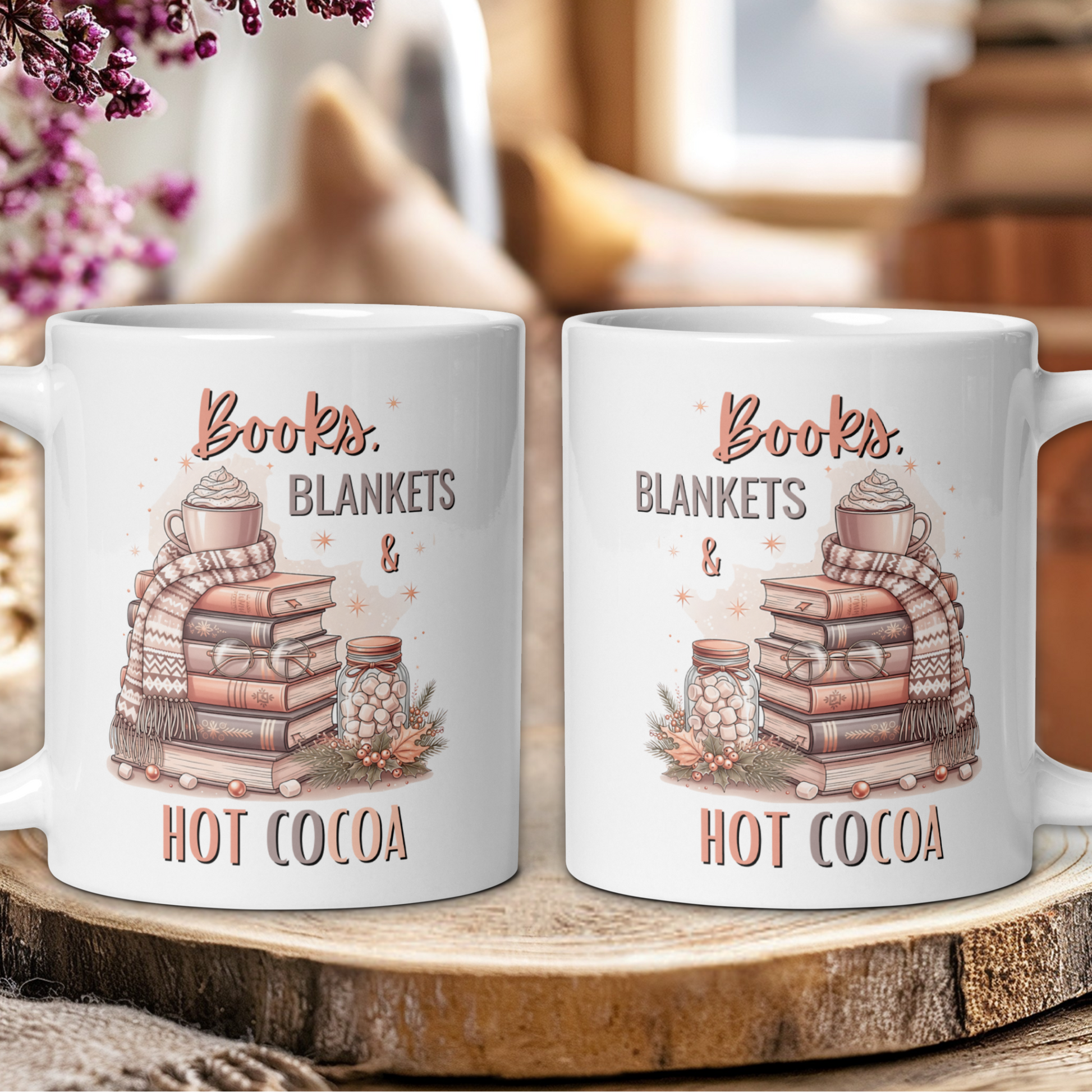 Two mugs with 'Books, Blankets & Hot Cocoa' design on a wooden surface.