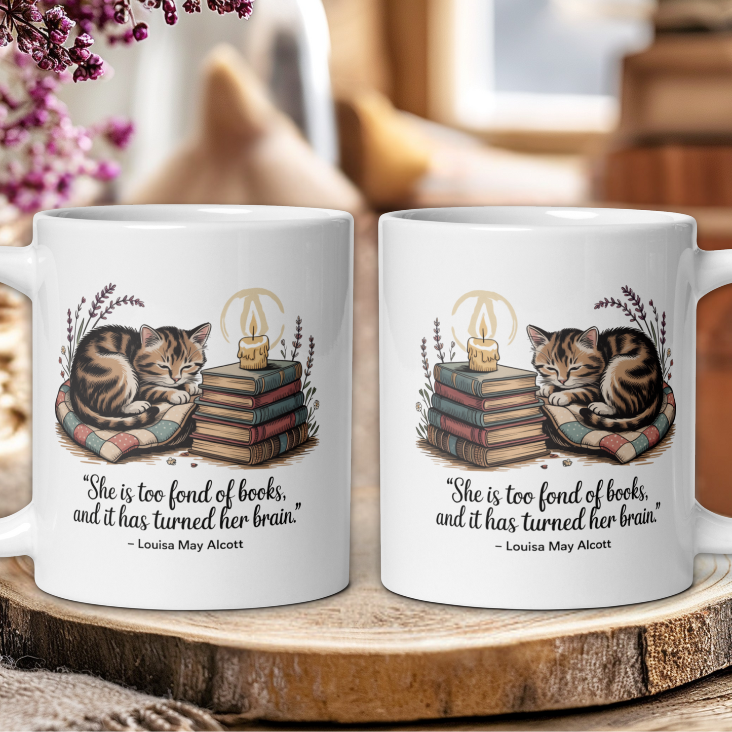 Two mugs with cat illustrations and book-themed design on a wooden surface.