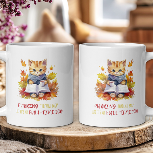 Two white mugs with a cat illustration and text on a wooden surface.