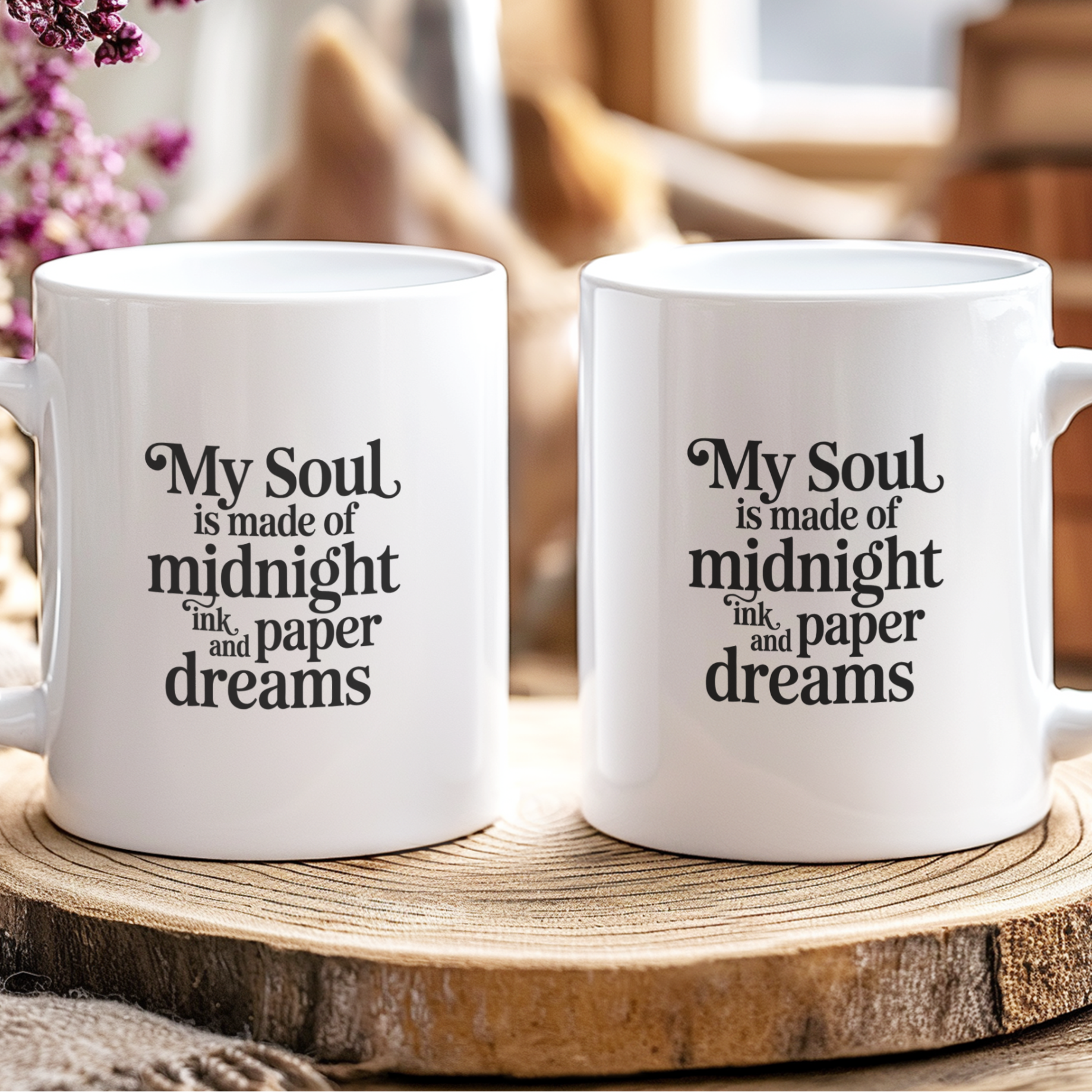 Two white mugs with a poetic quote on a wooden surface with a blurred background