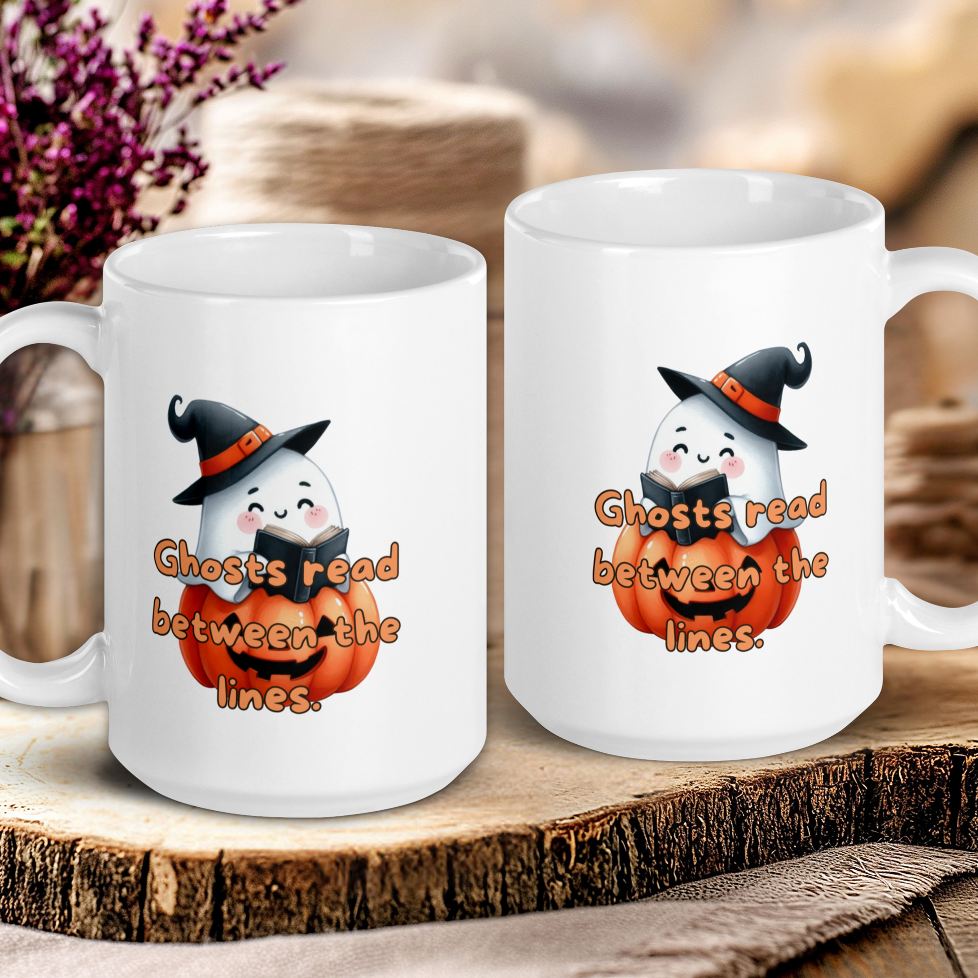 Two Halloween-themed mugs with ghost illustrations and text on a wooden surface.