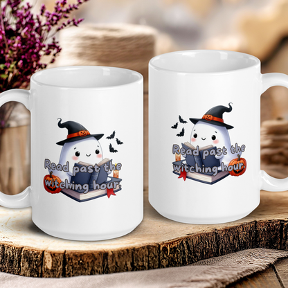 Two white mugs with Halloween-themed designs on a wooden surface.
