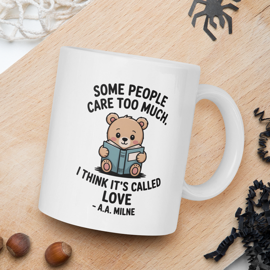 White mug with teddy bear graphic and text on a wooden board with natural elements.
