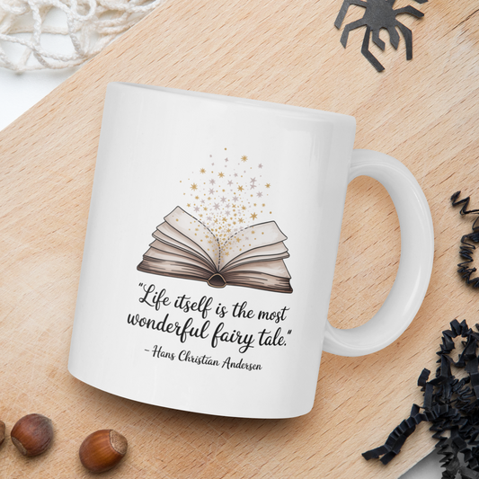 White mug with a book design and text on a wooden board with nuts and spider decorations.